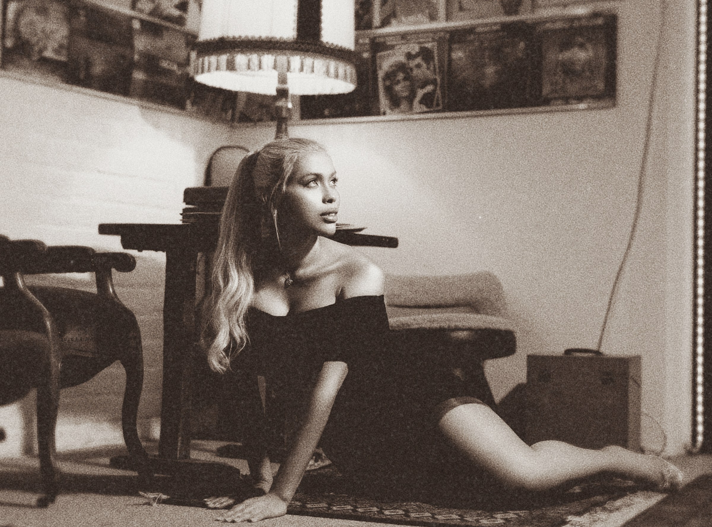 Miss Ives in a vintage room with records and lamplight